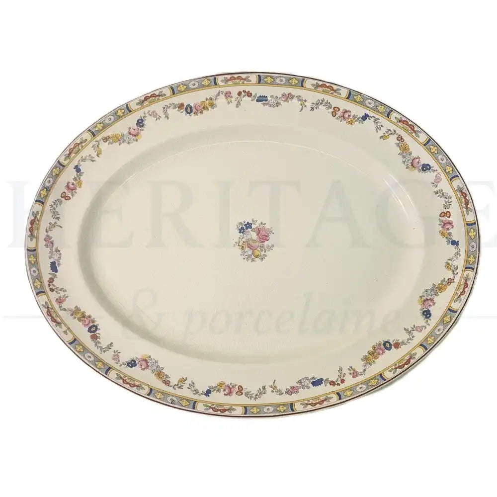 Johnson Brothers Arundale 16 1/16" oval serving platter featuring a classic floral pattern.
