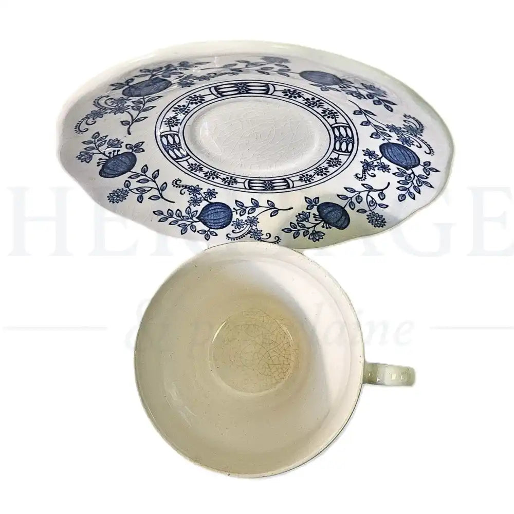 Wedgwood Blue Onion flat cup and saucer set featuring a classic blue and white floral pattern.